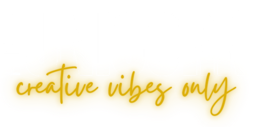 Logo of Fifth Unicorn in white with transparent background, and subheading in cursive gold neon: creative vibes only.